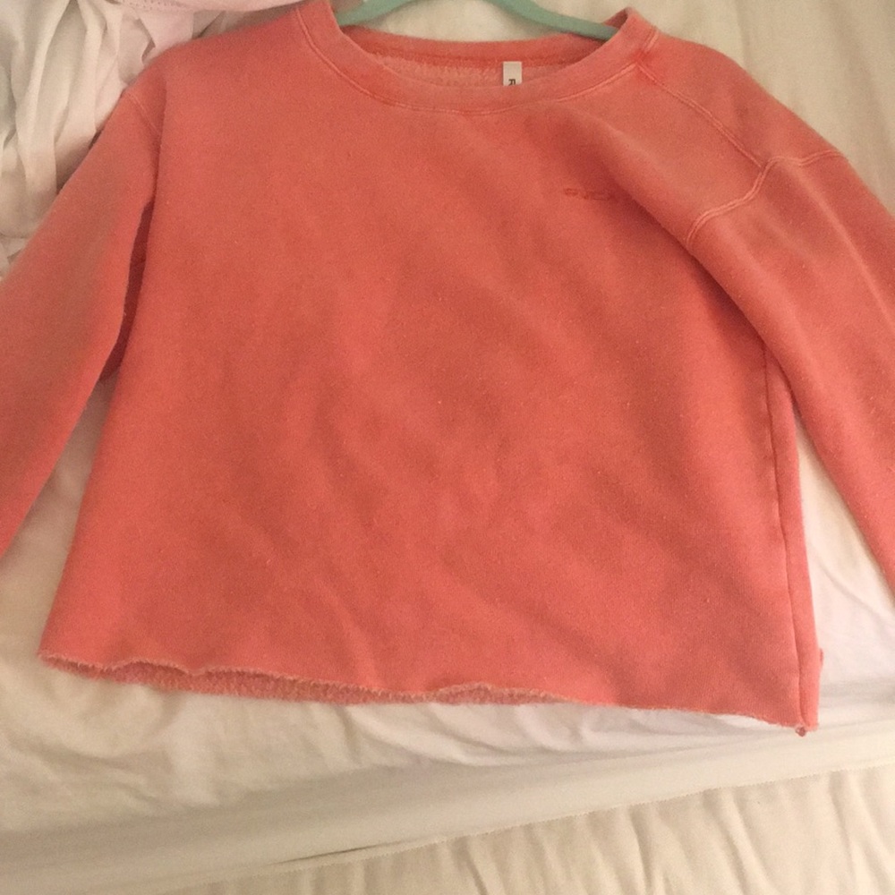 Peach colored, long sleeved